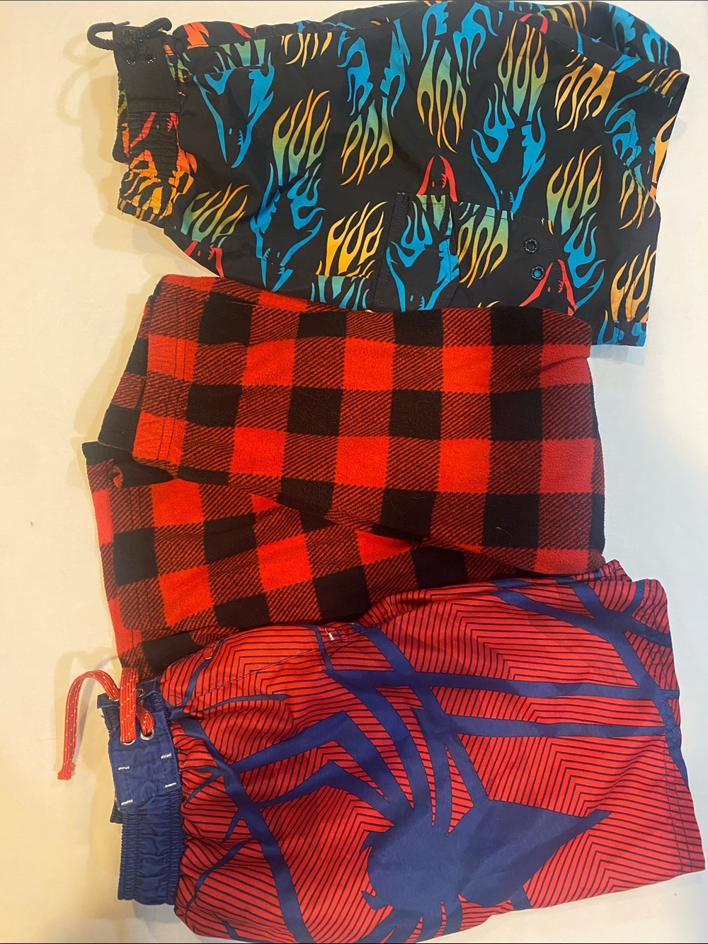 Boys, 2 swim trunks and 1 set of fleece pajama pants size 6/7